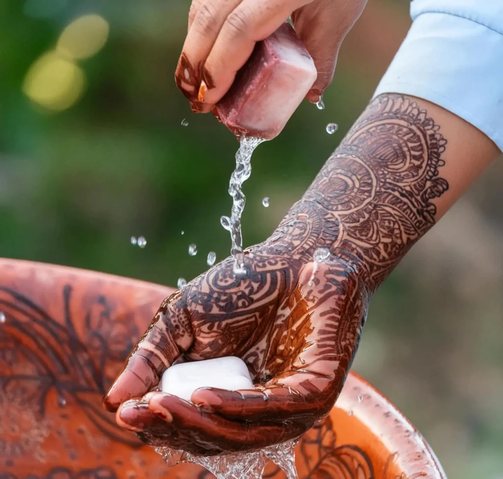 Using soap and warm water is a common method to help remove or lighten henna stains from the skin.